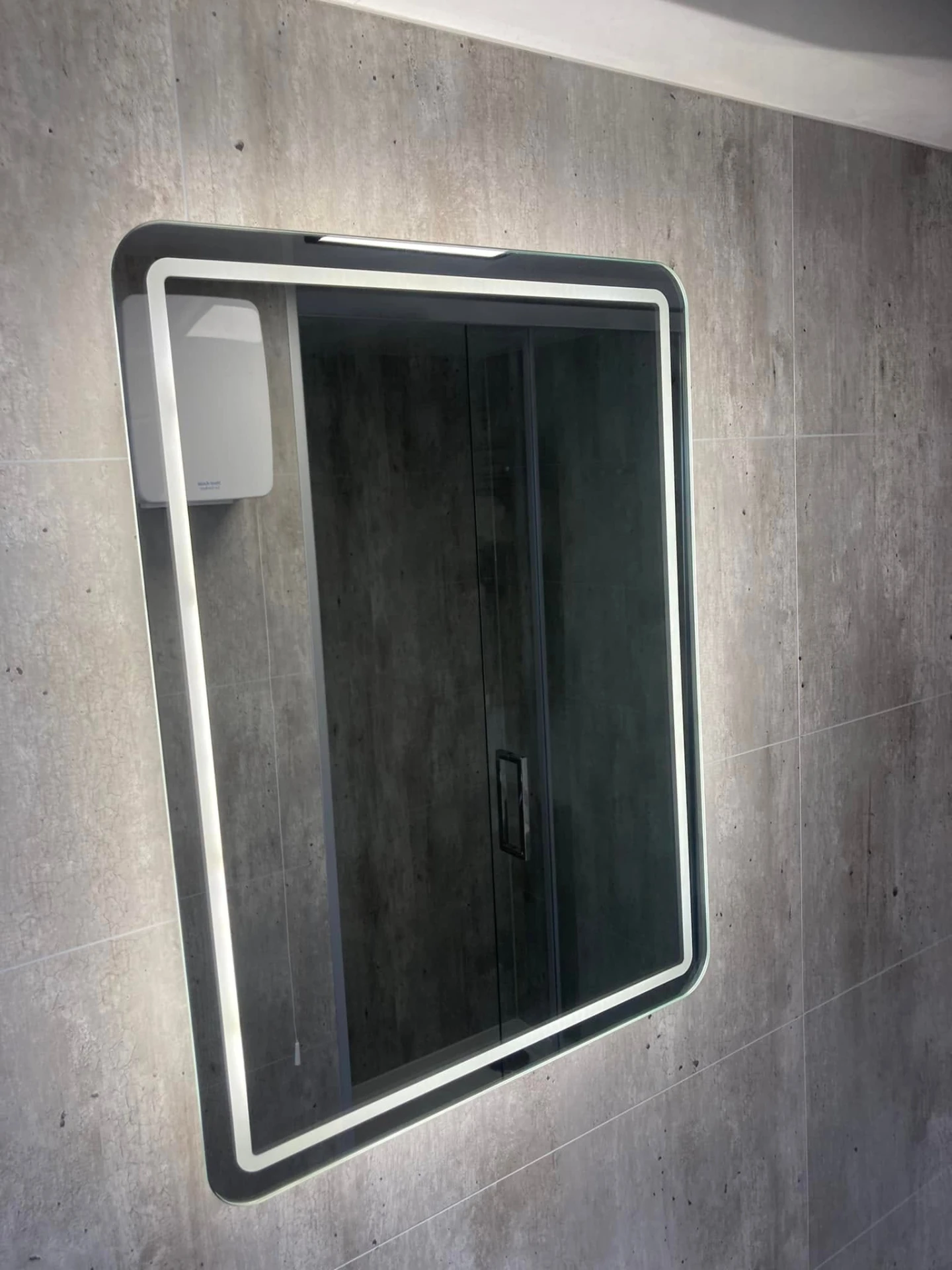 LED backlit mirror inside a shower pod