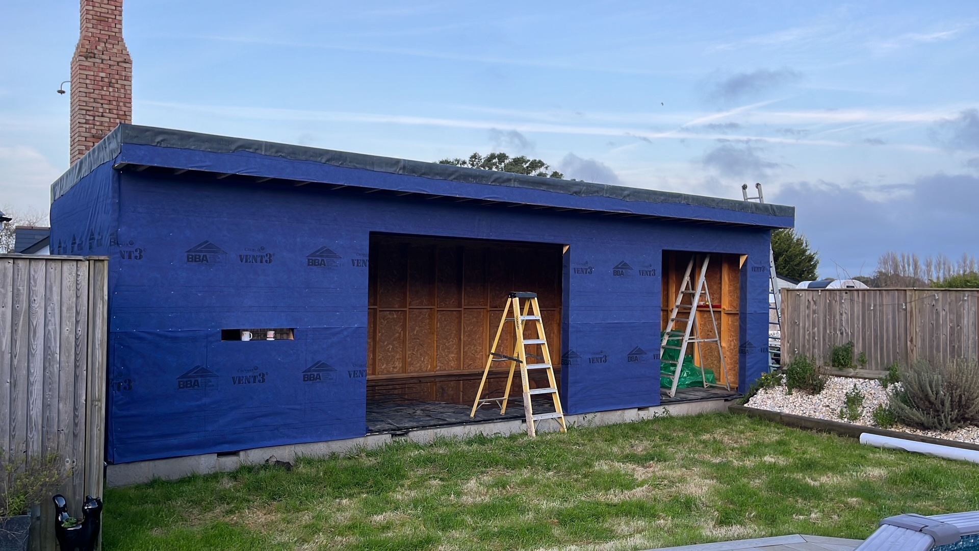 Garden room timber frame wrapped in breather membrane during construction