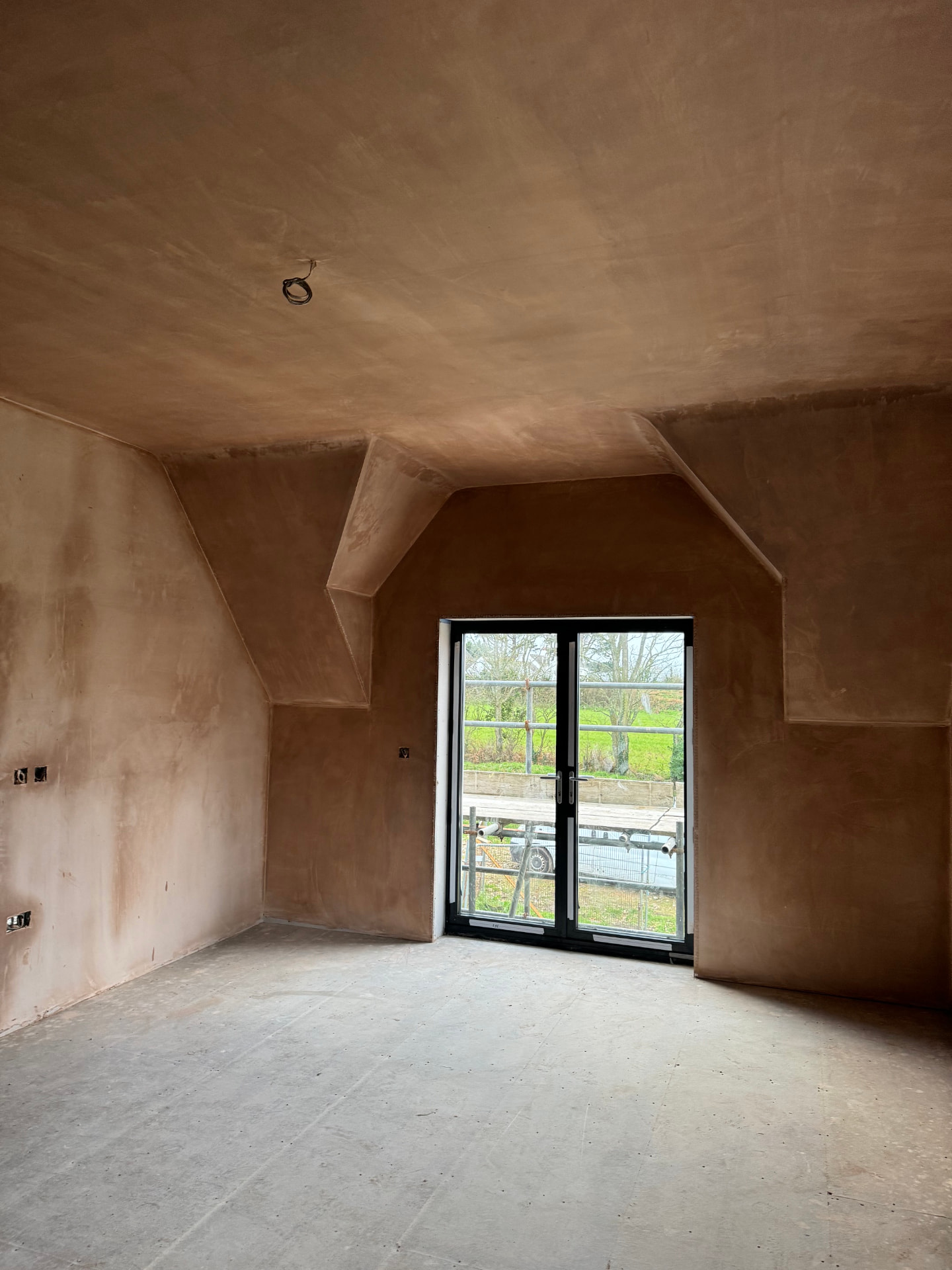 Freshly plastered bedroom with French doors in the newbuild