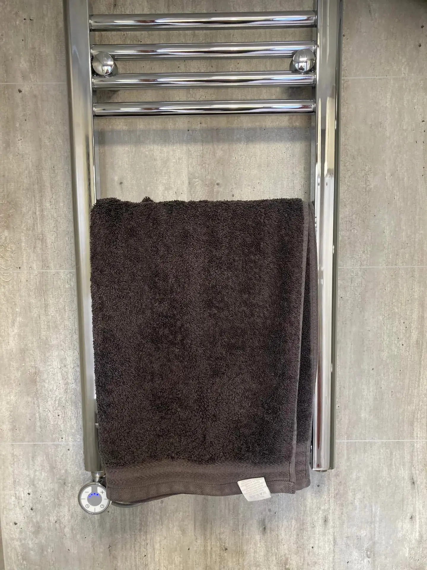 Heated chrome towel rail inside a shower pod