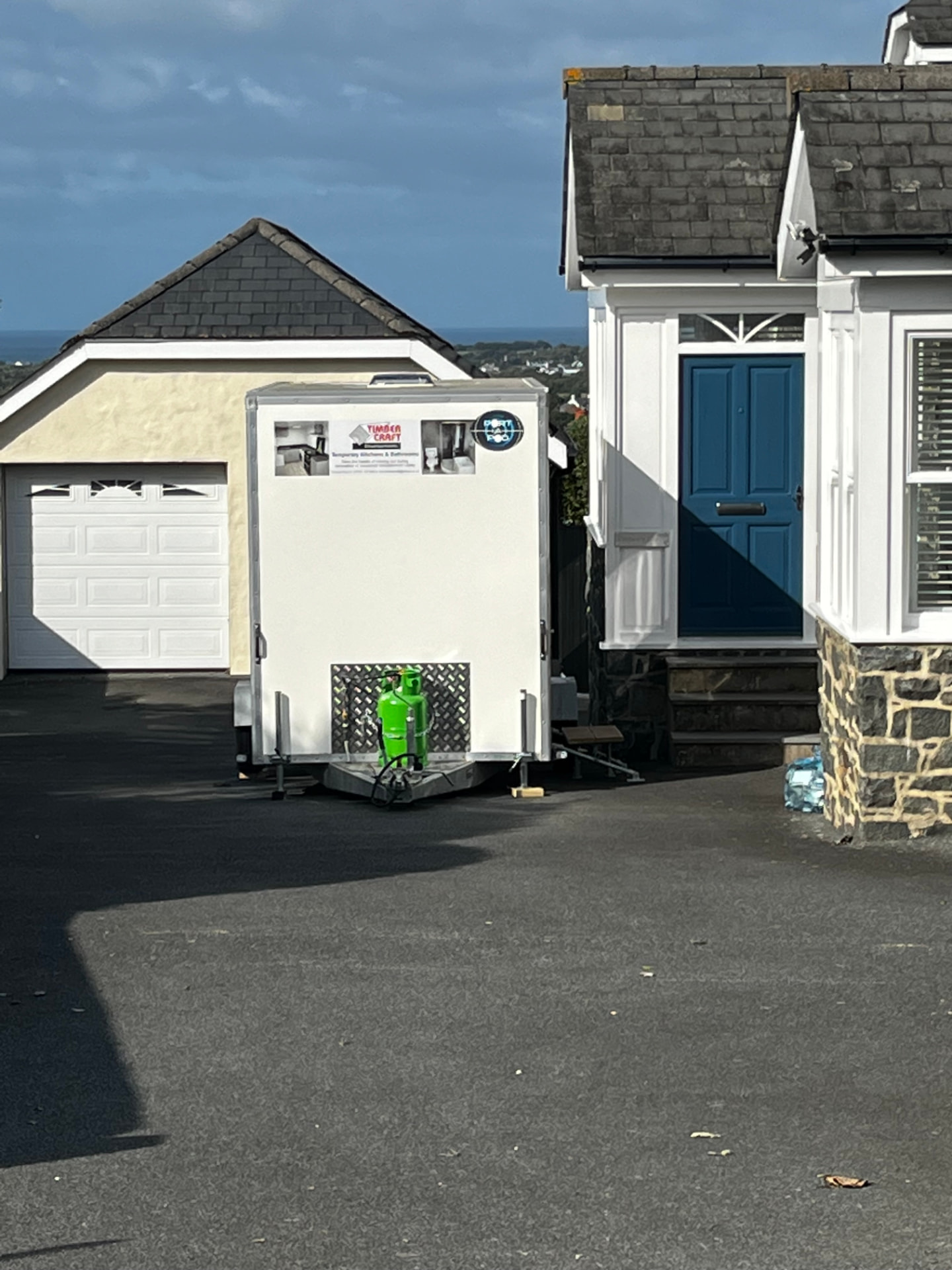 A Timber Craft Developments branded pod delivered on a residential driveway