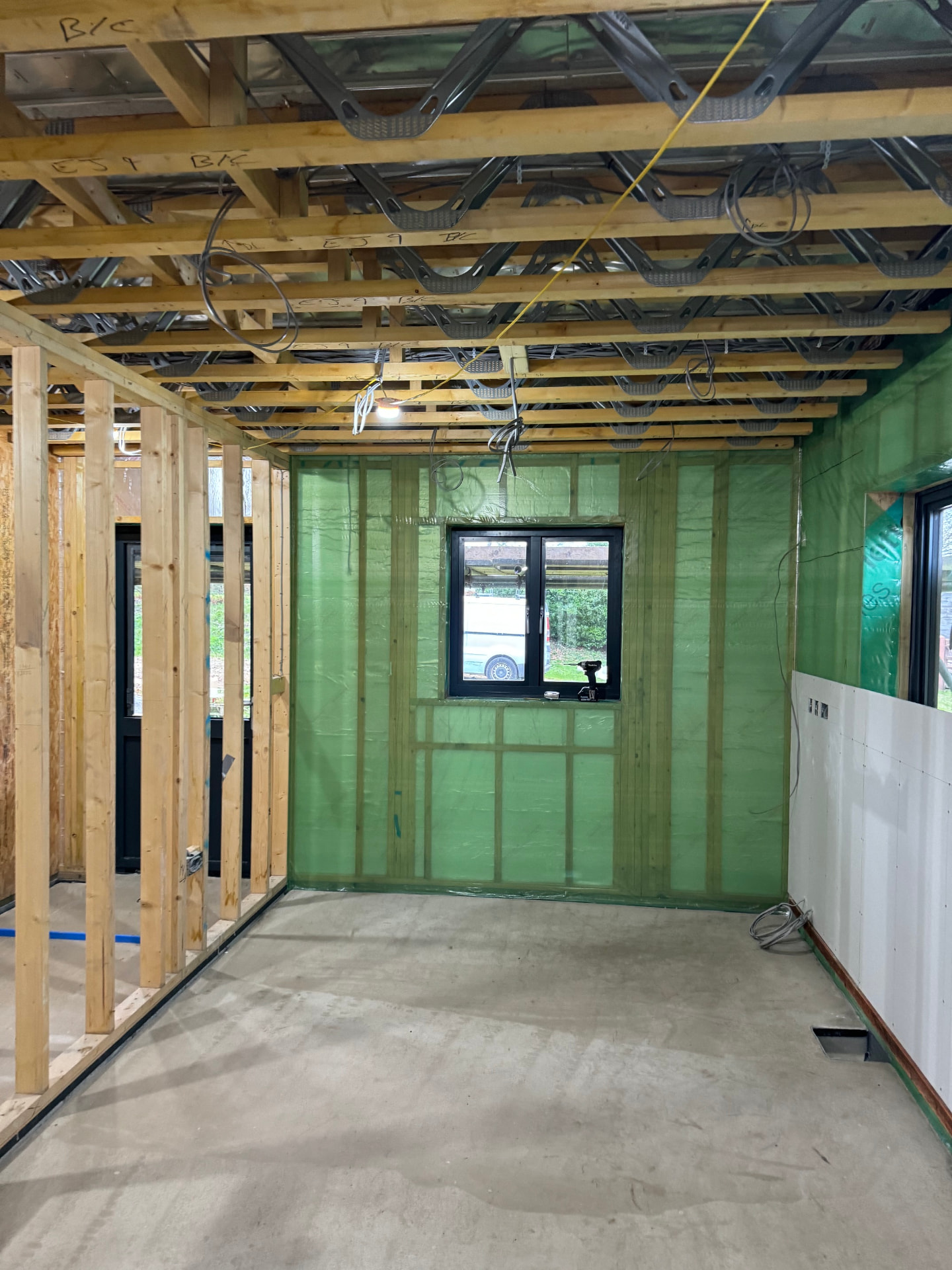 Interior stud walls, joists and membrane before plasterboarding