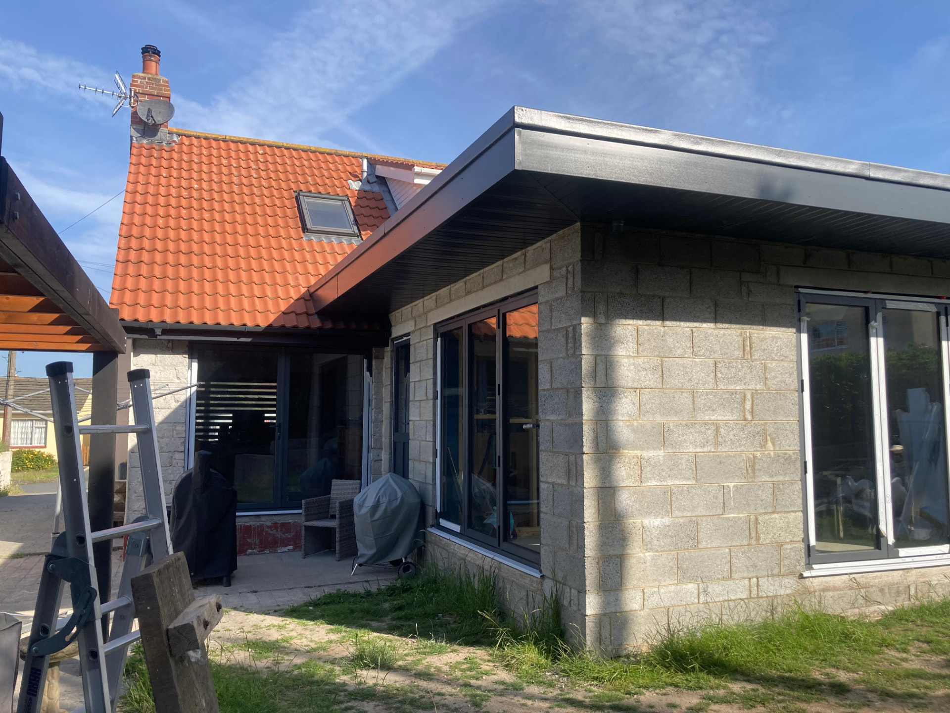 Extension under construction with blockwork walls and new sliding doors