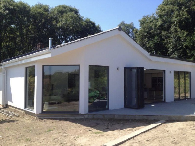 A finished single-storey newbuild with full-height glazing and bi-fold doors
