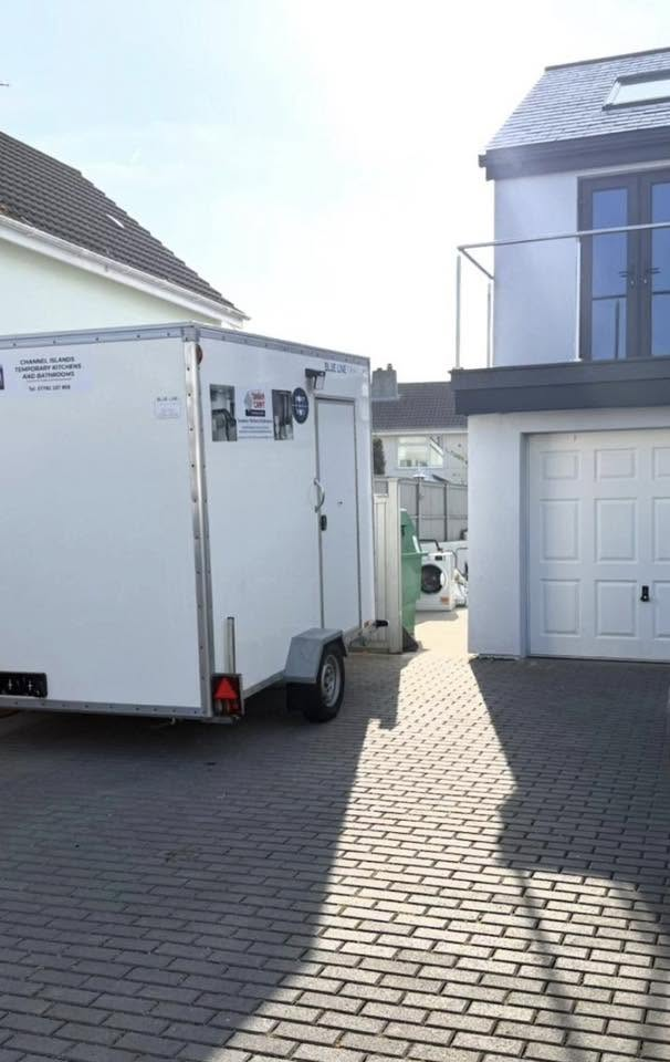 A temporary pod parked on a residential driveway in Guernsey